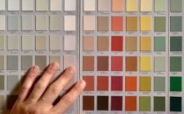 hand choosing colors to paint wall