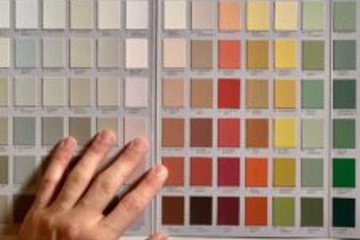 hand choosing colors to paint wall