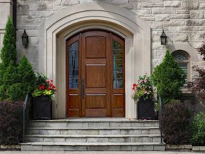 wooden front door under curved archway