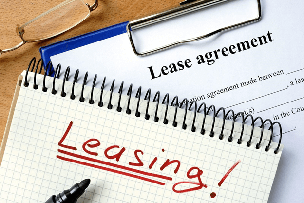notepad and pen on top of lease agreement