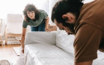 couple putting covers on the armchair