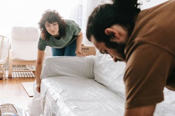 couple putting covers on the armchair