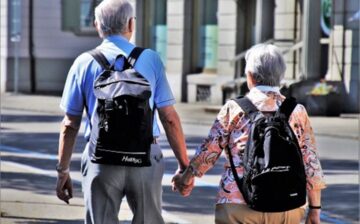 elderly couple walking hand in hand