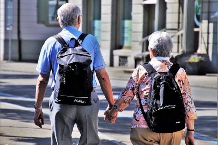 elderly couple walking hand in hand