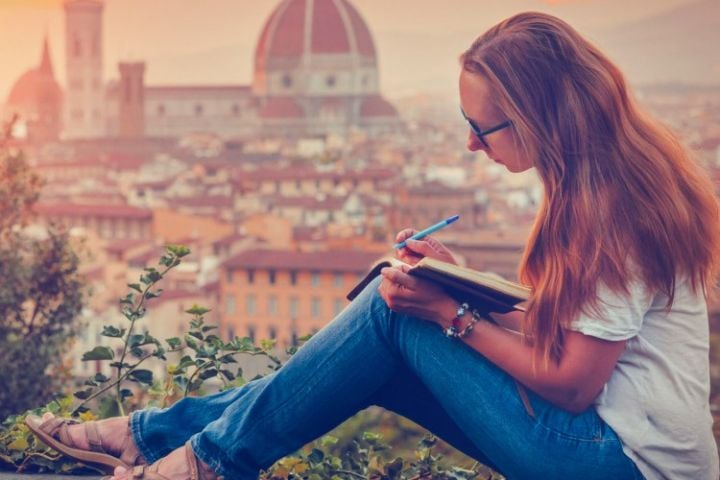 woman writing travel diary