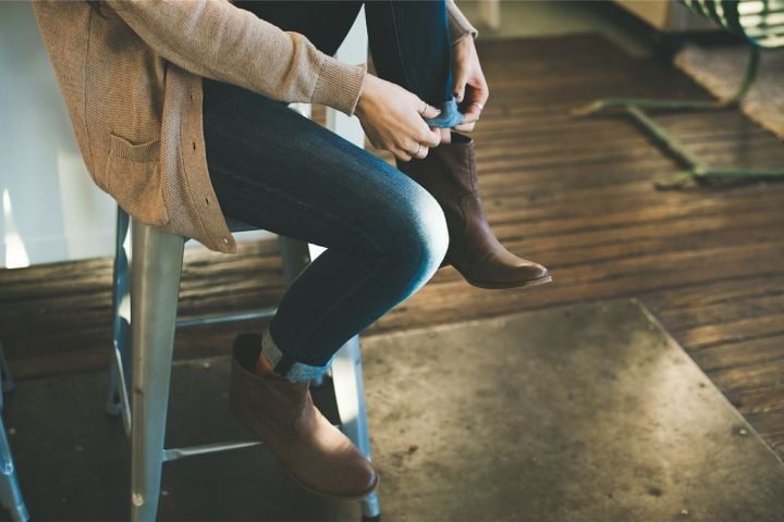 woman's legs sitting on a bench