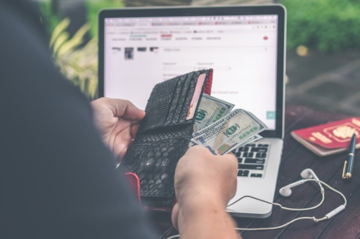 A man counting money in his wallet