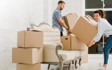 a couple is Moving into a new house boxes