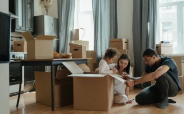 parents with a child and moving boxes