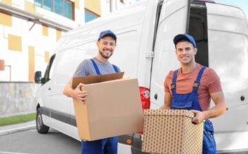 2 movers holding boxes for Moving Service Company