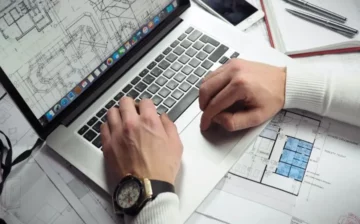 man typing on his laptop computer