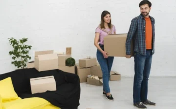 a man and a women moving boxes