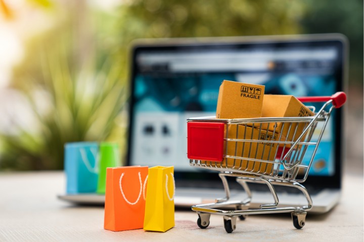 shopping cart with boxes and bags and computer