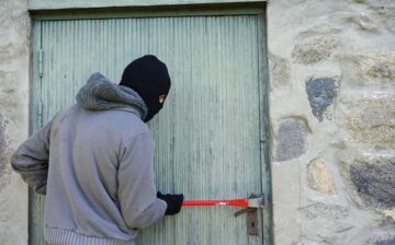 thief trying to break into a house