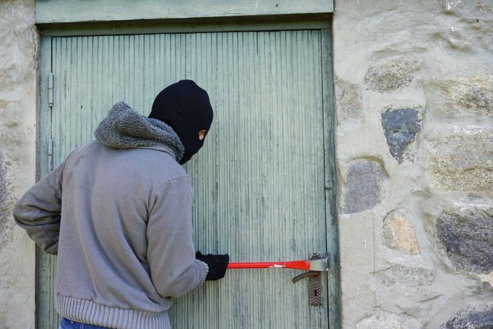 thief trying to break into a house