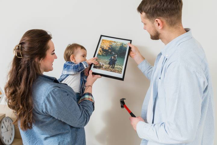 family with baby watching photo