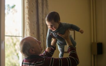 grandparents holding grandson