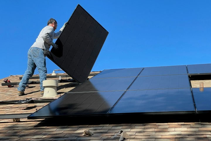 man placing solar panels