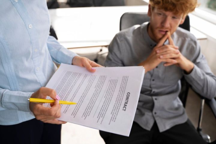 man reviewing contract with employee