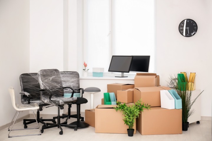 office with packed chairs and moving boxes