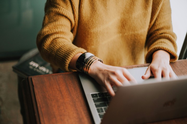 Woman researches moving companies on a laptop