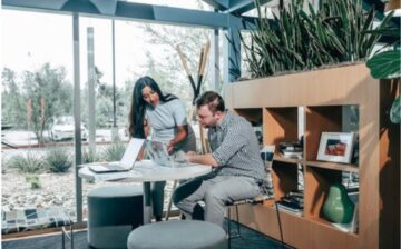 office with glass walls and couple working