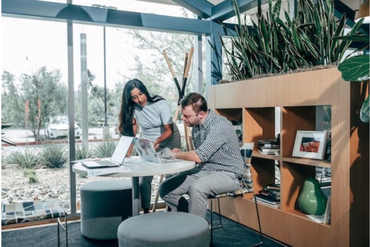 office with glass walls and couple working