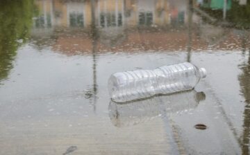 plastic bottle lying in puddle of water