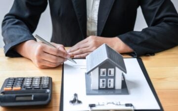 real estate business man at desk with mockup house