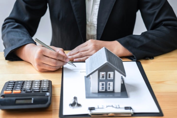 real estate business man at desk with mockup house