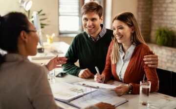 couple signing house mortgage