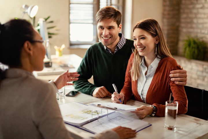 couple signing house mortgage