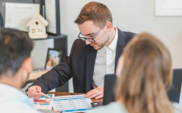 real estate agent showing papers to sign