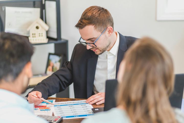 real estate agent showing papers to sign