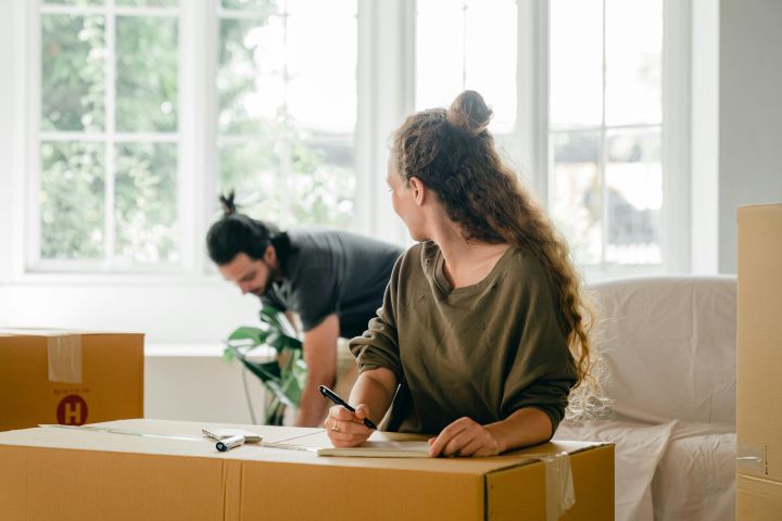 couple labeling moving boxes