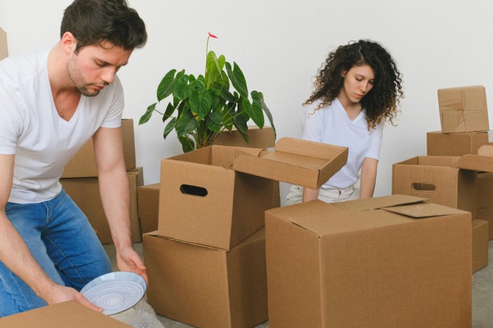 couple organizing moving boxes in their new house