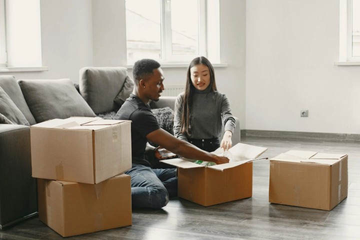 couple packing moving box