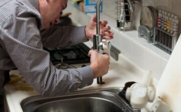 man fixing pipe