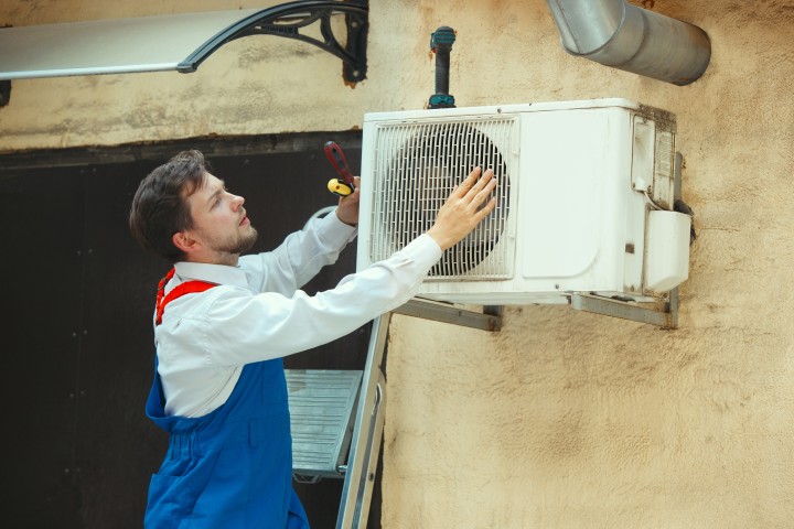 man installing air conditioning