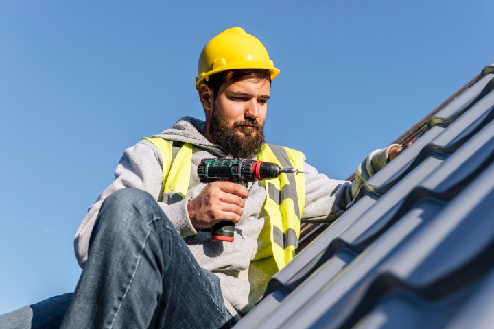 man working on roof repair