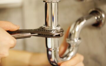 plumber fixing pipe