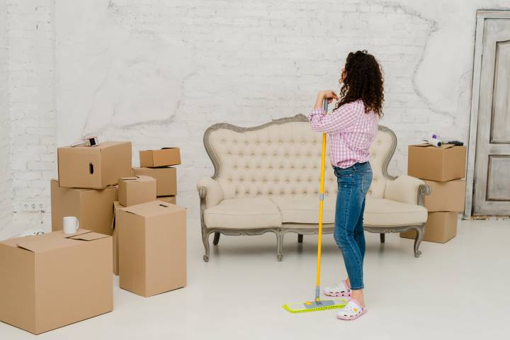 woman cleaning her old house before moving