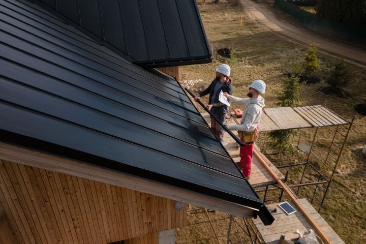 workers placing roof