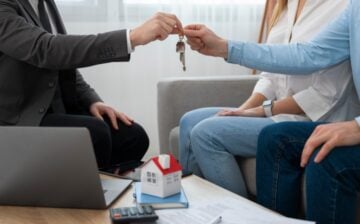 couple grabbing the keys to their new house