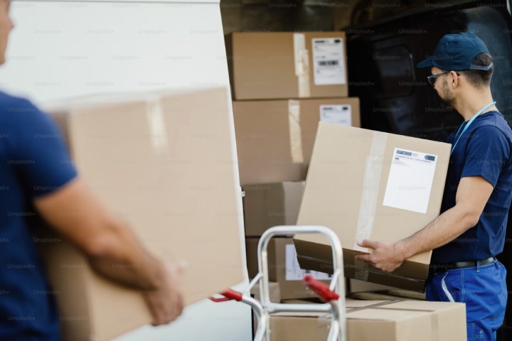 professionals loading moving boxes on truck