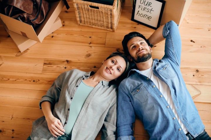 view couple lying down floor their new home
