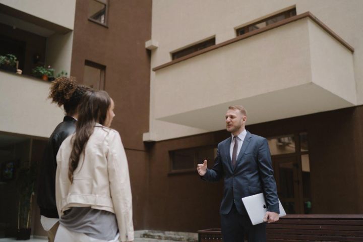 Female couples with real estate salesman