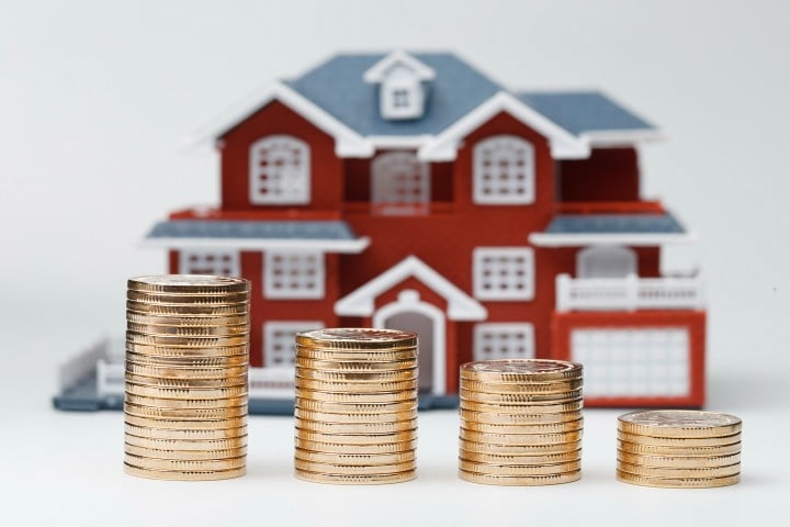 Miniature house with coins
