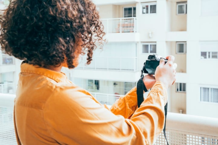 Woman taking photo of real estate property in Denver