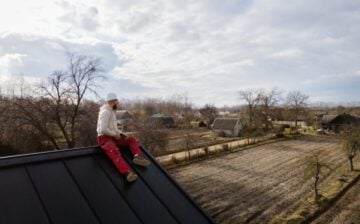 man sitting on the edge of the roof